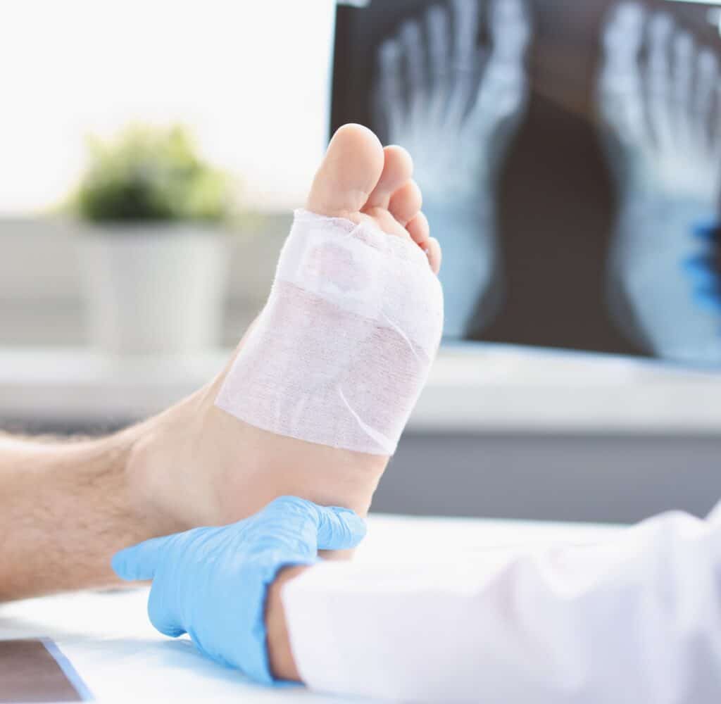 A podiatrist examines the foot of a patient at Eaton Rapids Medical Center